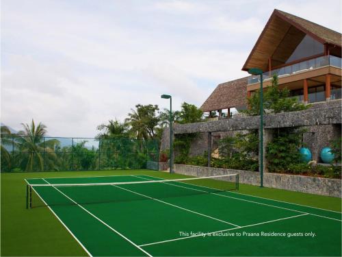 a tennis court in front of a house at Panacea Retreat in Bophut 
