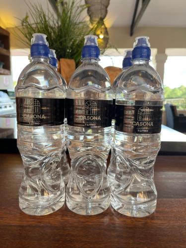 three bottles of water sitting on top of a table at Boutique Hotel La Casona in Valle de Ángeles