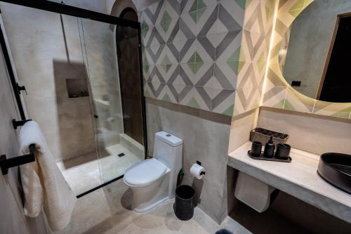 a bathroom with a toilet and a shower and a sink at Casa 1800 Oaxaca Boutique Hotel City Center based in Oaxaca City