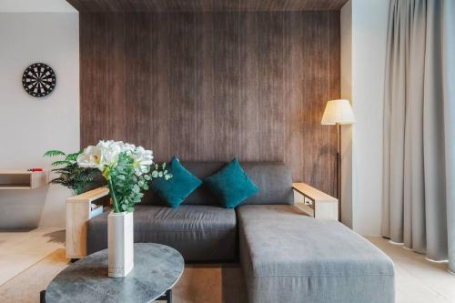 a living room with a couch and a table at Lumi Tropicana Muji Concept in Petaling Jaya