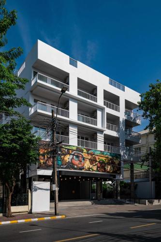 a white building with a mural on the side of it at The StandardX, Bangkok Phra Arthit in Bangkok