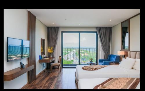 a hotel room with a bed and a large window at Vipol Mui Ne Hotel & Spa in Mui Ne
