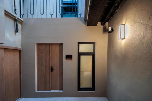 a hallway with a door and a mirror on the wall at Casa 1800 Oaxaca Boutique Hotel City Center based in Oaxaca City