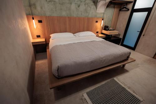 a bedroom with a large bed with a wooden headboard at Casa 1800 Oaxaca Boutique Hotel City Center based in Oaxaca City