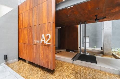 a hotel room with a sign on a wooden wall at Lumi Tropicana Muji in Petaling Jaya