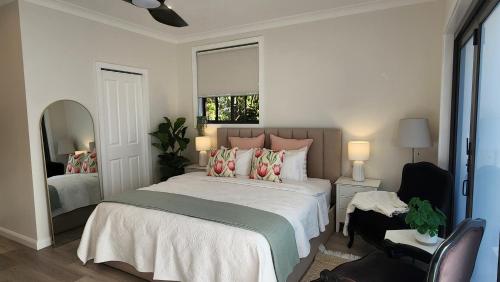 a bedroom with a large bed and a mirror at Little Lux at The Grove in Sydney