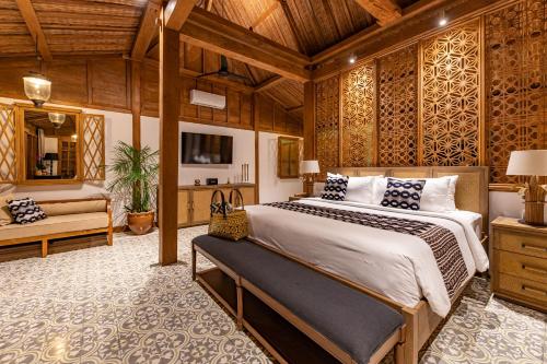 a bedroom with a large bed in a room at Umah Lusa in Munduk