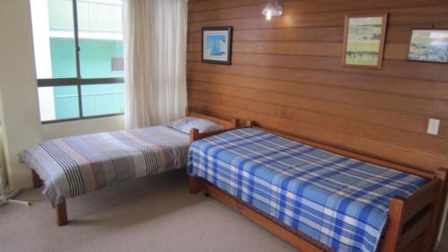 a bedroom with two beds and a window at Seamist Lodge Unit 5 in Caloundra
