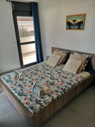 a bed sitting in a room with avertisement at Clairs Moments in Saint-Pierre
