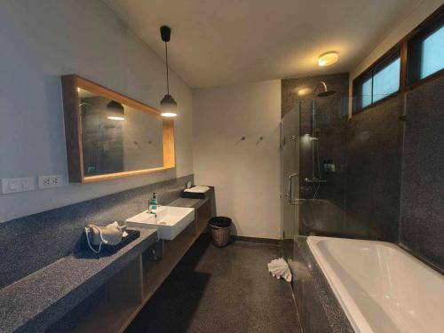 a bathroom with a tub and a sink and a shower at Casa De Mar - Koh Samui in Chaweng