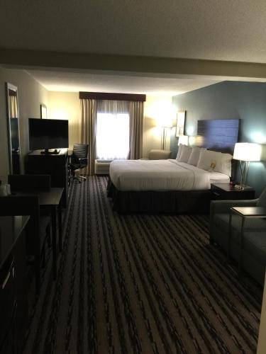 a hotel room with a large bed and a window at Holiday Inn Harrisburg East by IHG in Middletown
