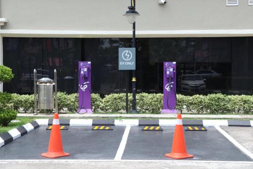 a parking lot with orange cones in front of a dealership at Perdana Kota Bharu in Kota Bharu