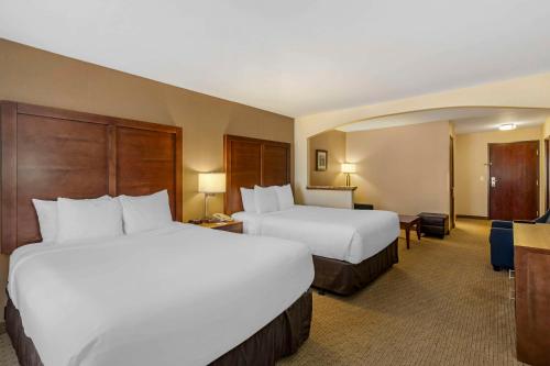 a hotel room with two beds and a desk at Comfort Inn & Suites Gillette near Campbell Medical Center in Gillette