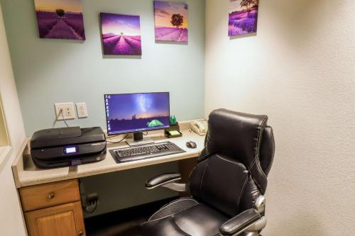 an office with a desk with a computer and a chair at Quality Inn & Suites Sequim at Olympic National Park in Sequim