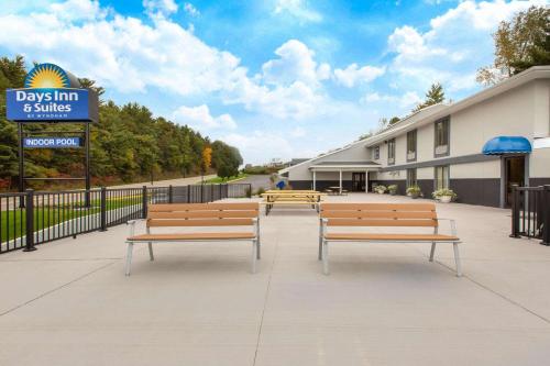 a row of benches in front of a building at Days Inn & Suites by Wyndham Wisconsin Dells in Wisconsin Dells