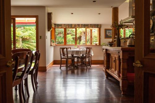 a kitchen and dining room with a table and chairs at Awatuna Homestead in Awatuna