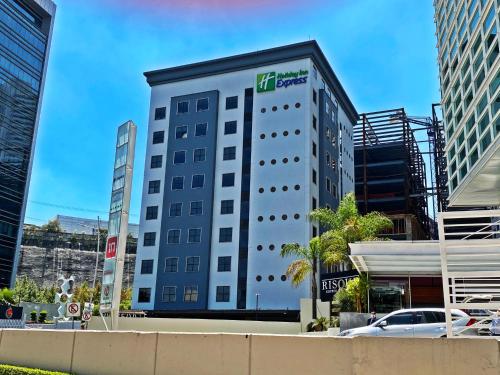 a tall white building with a sign on it at Holiday Inn Express Mexico Santa Fe by IHG in Mexico City
