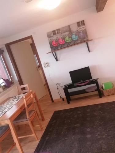 a living room with a desk and a computer on a wall at Ferienhaus RhönFlair in Fladungen