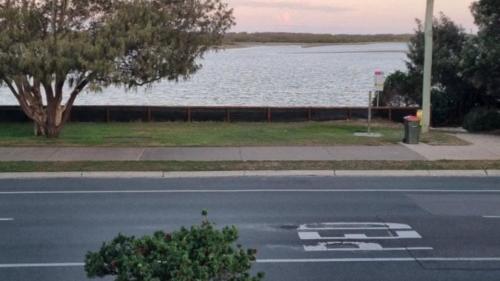 an empty street with a view of a body of water at #1 Seascape, Golden Beach Waterfront Location in Golden Beach