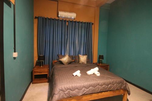 a bedroom with a bed with two polar bears on it at Bat Chum Villa in Phnom Penh