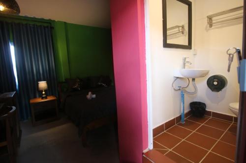 a bathroom with green and pink walls and a sink at Bat Chum Villa in Phnom Penh