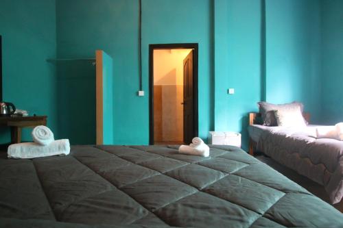 a bedroom with a large bed and a door to a room at Bat Chum Villa in Phnom Penh