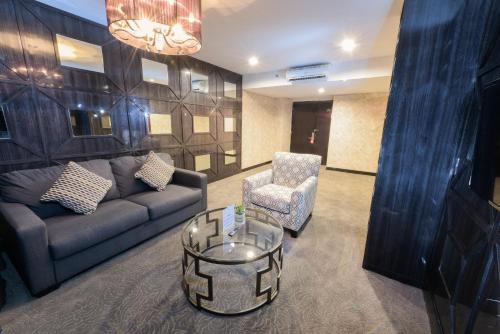 a living room with a couch and a chair at Royal Regantris Cendana in Surabaya
