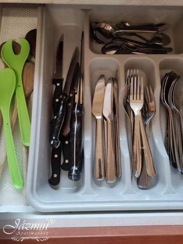 a drawer full of utensils in a drawer at Jázmin Apartmanház in Szentgotthárd