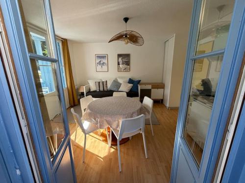 un salon avec une table et un canapé dans l'établissement Charmant T2bis, belle vue centre, à Cauterets