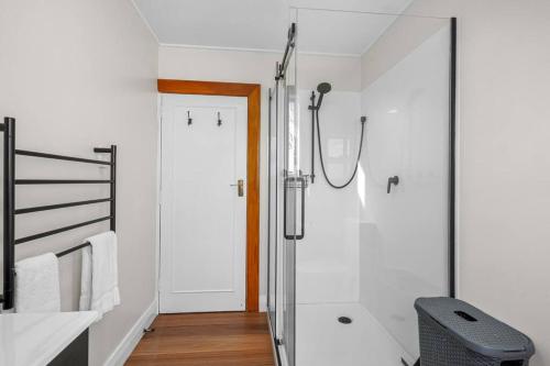 a bathroom with a shower with a glass door at Morgan's Treasure in Hanmer Springs