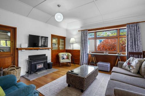 a living room with a couch and a fireplace at Morgan's Treasure in Hanmer Springs