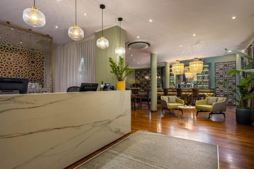 a lobby with a marble counter and chairs at Hotel Indigo Turin by IHG in Turin