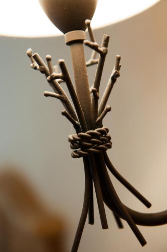 a close up of a chandelier with twigs at Logis Auberge Du Mehrbachel - Hôtel & Restaurant in Saint-Amarin