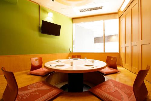 a waiting room with a table and chairs at Mars Garden Hotel Hakata in Fukuoka