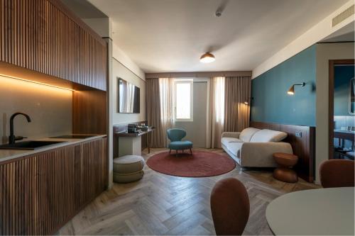 a living room with a couch and a table at Visionair Suites & SPA-Room Only e Honesty Bar in Senigallia