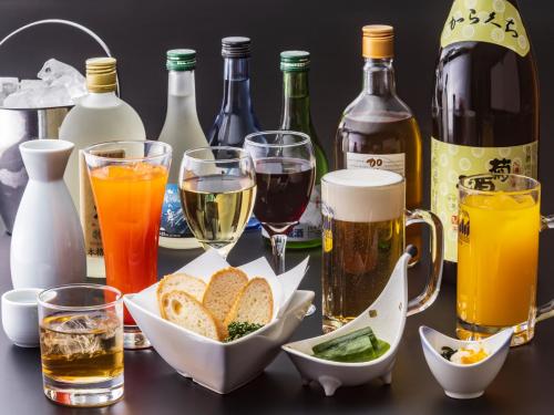 a table with bottles of wine and glasses of food at Hotel Green Plaza Hamanako in Hamamatsu