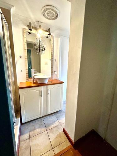 a bathroom with a sink and a mirror at Executive Accommodation Bellville 2 in Cape Town