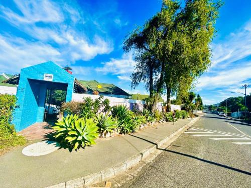 a blue building on the side of a street at Executive Accommodation Bellville 2 in Cape Town