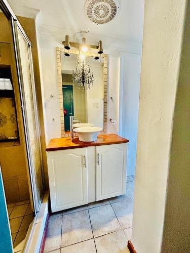 a bathroom with a sink and a mirror at Executive Accommodation Bellville 2 in Cape Town