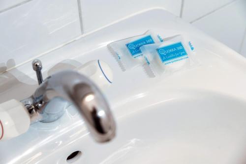 a sink with a toothbrush and tooth paste on it at Pink Flat 2 by Quokka 360 - At the border of Switzerland in Chiasso