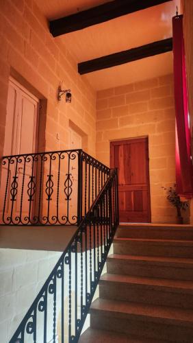 a spiral staircase in a building with a door at Ta Speranza Farmhouse B&B in Victoria