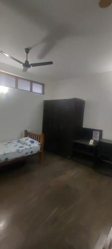 a room with a bed and a ceiling fan at The Hills Studio Appartment in Tiruvannāmalai