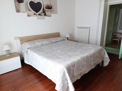 a bedroom with a bed with a white blanket at Fattoria Cristina - Bilo Verde in Castelnuovo Magra