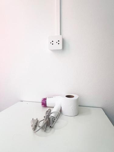 a bathroom with a roll of toilet paper and aswitch at Vonden Garden by Merry V in Bangkok