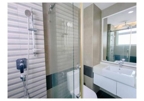 a bathroom with a toilet and a sink and a mirror at Setapak Central Premium Suites in Kuala Lumpur