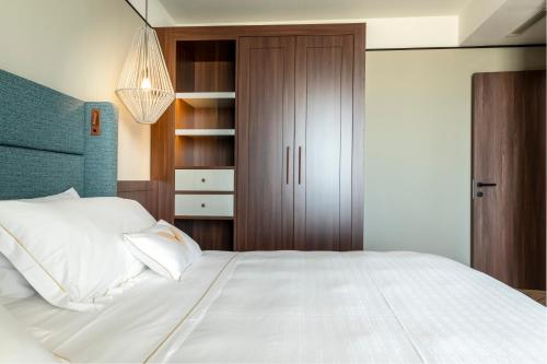 a bedroom with a large white bed and a closet at Visionair Suites & SPA-Room Only e Honesty Bar in Senigallia