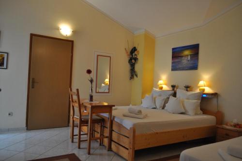 a bedroom with a bed and a table and chairs at Studios Lav in Privlaka