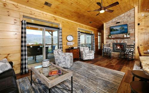 a living room with a couch and a fireplace at Holly Ridge Hideaway in Gatlinburg