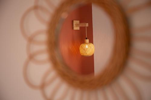 a reflection of a hanging light in a mirror at Le Cocon Digoinais in Digoin