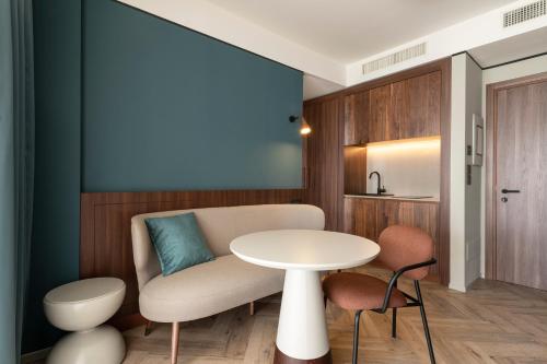 a living room with a table and a chair at Visionair Suites & SPA-Room Only e Honesty Bar in Senigallia